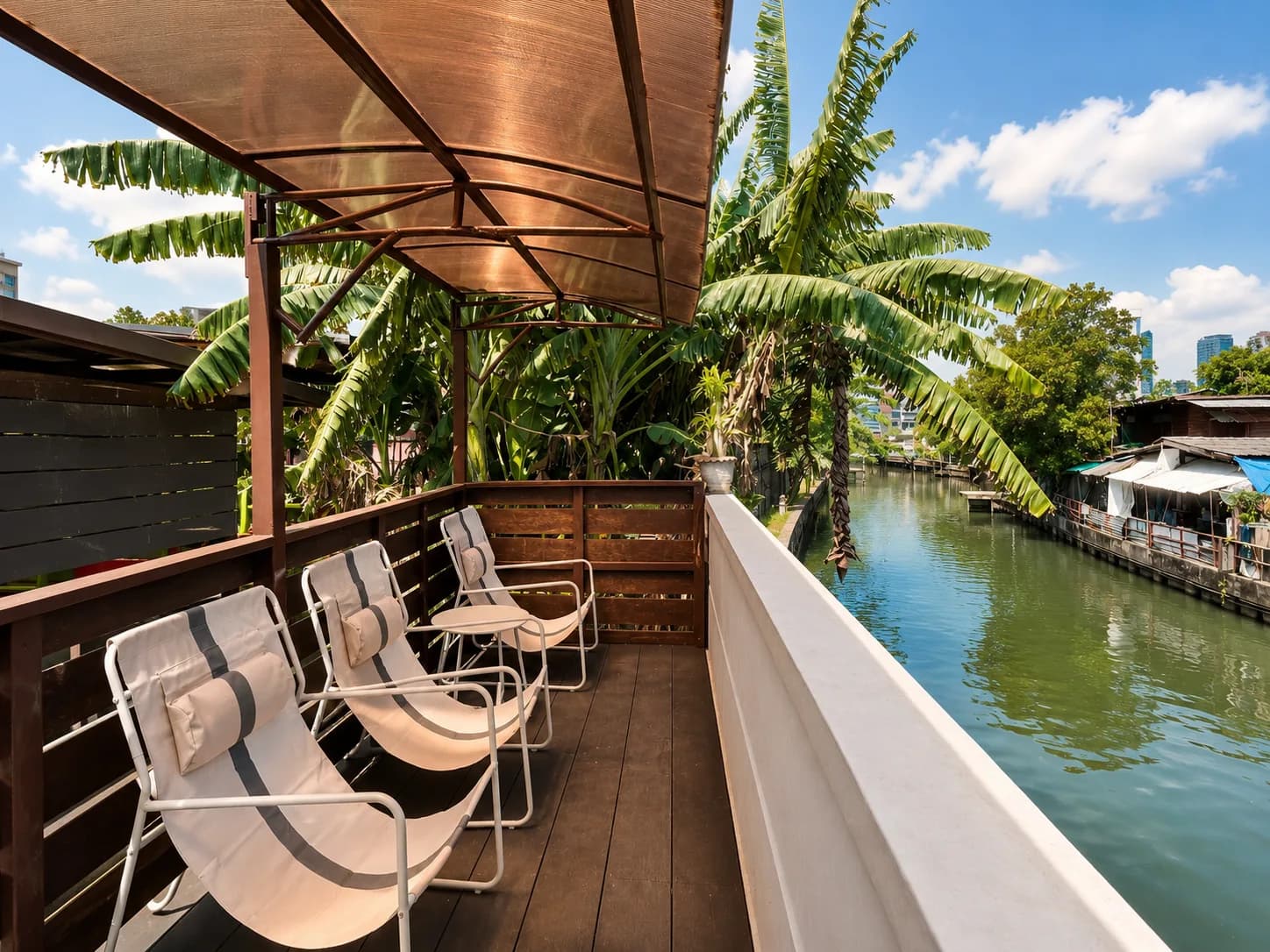 Covered canal-side deck with lounge chairs